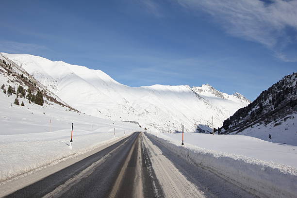 istock Black Aspahlt in a White Scenery, Zirmbach, Sellraintal, Tyrol, Austria 469964867