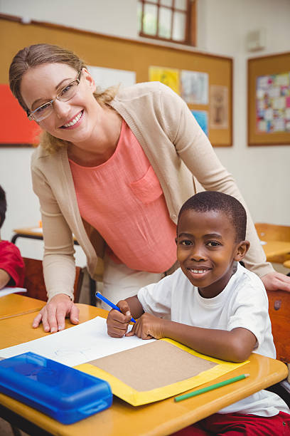 istock Caucasian teacher helping student in classroom 469967446