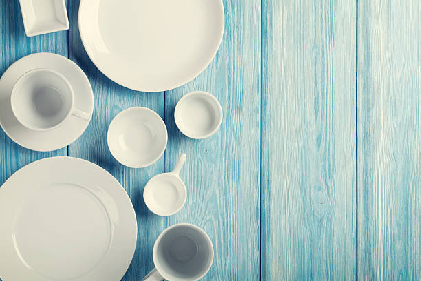 istock Empty plates and bowls on blue wooden background 469968028