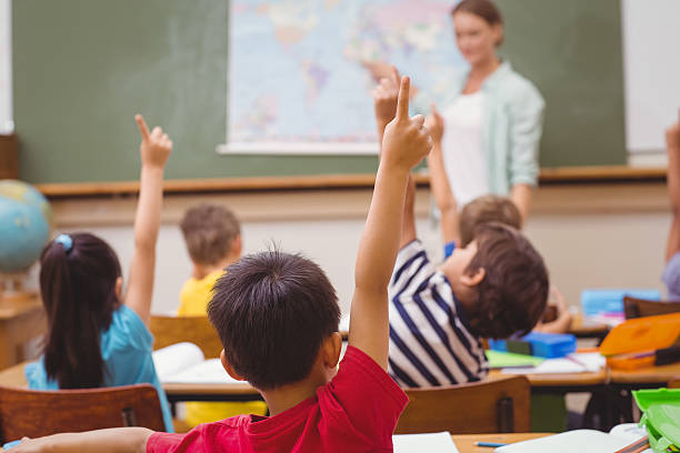 istock Pupils raising hand during geography lesson in classroom 469968418