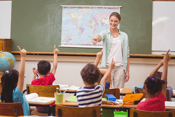 istock Pupils raising hand in classroom 469968538