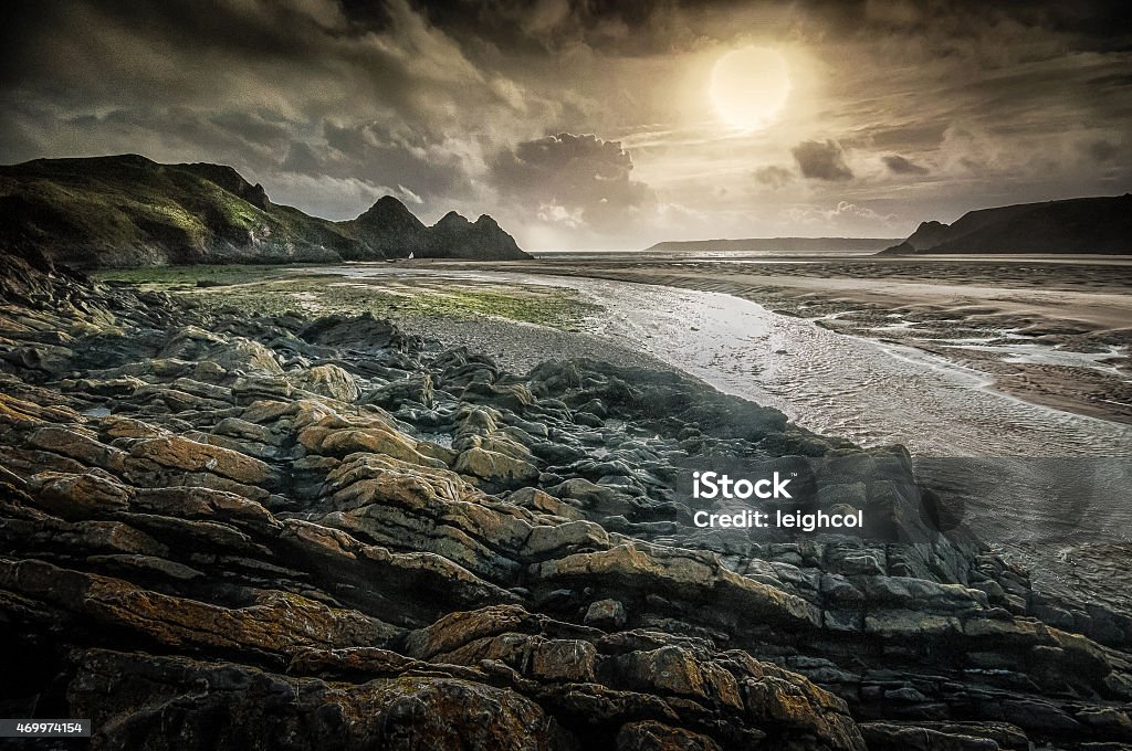 Moody Three Cliffs Bay Gower Three Cliffs Bay on the Gower peninsular, Swansea, looking like a Lord of the Rings secene 2015 Stock Photo