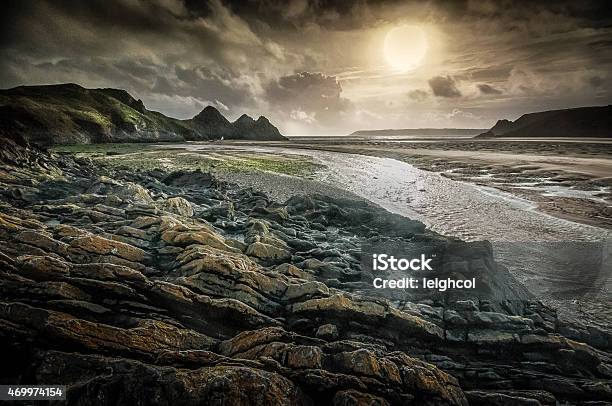 Moody Three Cliffs Bay Gower Stock Photo - Download Image Now - 2015, Beach, Cliff