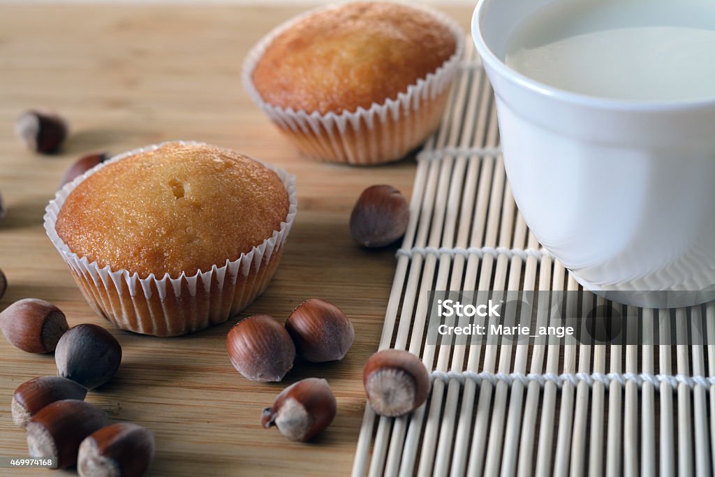 closeup of cupcakes with hazelnut filling closeup of cupcakes with hazelnut filling and a cup of milk 2015 Stock Photo