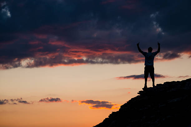 istock Man Raises Arms in Excited Elation atop Mountain Summit 469974235
