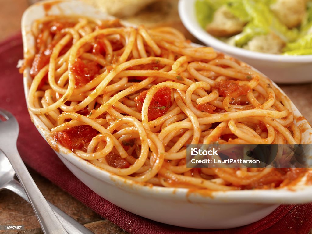 Spaghetti in Tomato Sauce Spaghetti in Tomato Sauce with freshly grated Parmesan cheese, Caesar Salad and Garlic Bread -Photographed on Hasselblad H3-22mb Camera Baguette Stock Photo