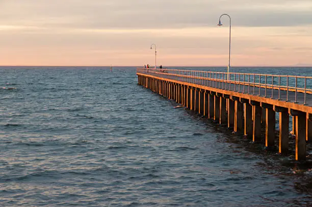 31 August 2013 - Dromana Pier on the Mornington Peninsula, Victoria, Australia at sunset.  The pier protrudes into Port Phillip Bay.
