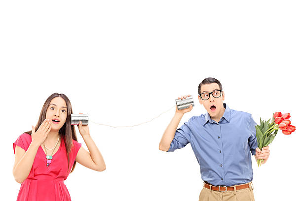 istock Man and a woman talking through a tin can phone 469977292