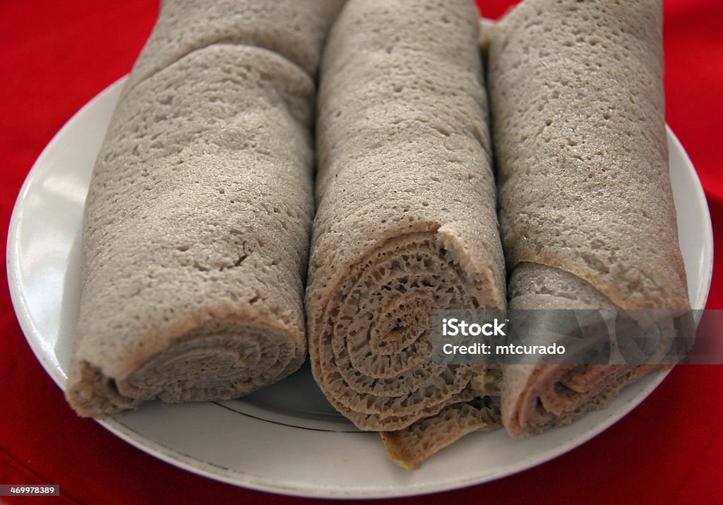 A plate of rolled injera in Ethiopia Bahir Dar, Amhara, Ethiopia: rolled injera, the national staple, made from teff - Ethiopian sourdough flatbread / pancake - photo by M.Torres Injera Stock Photo