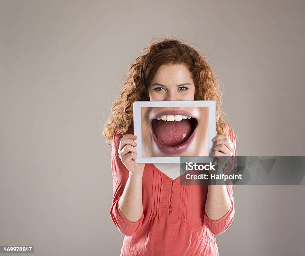 Young Woman Holding Oversized Picture Of An Open Mouth Stock Photo - Download Image Now