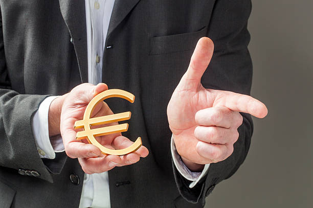 istock banker displaying currency in his hands 469981034