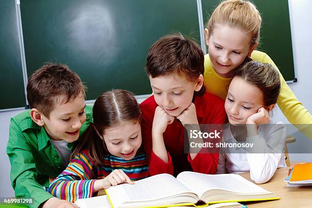 Reading Lesson Stock Photo - Download Image Now - 2015, Book, Boys