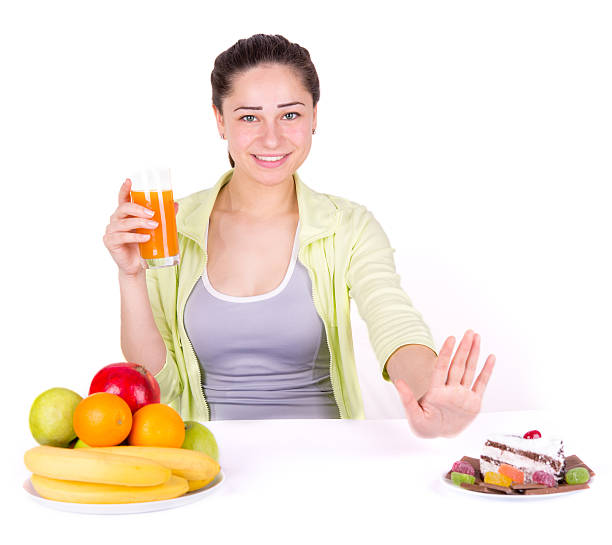 istock girl chooses fruit instead of sweets 469982766