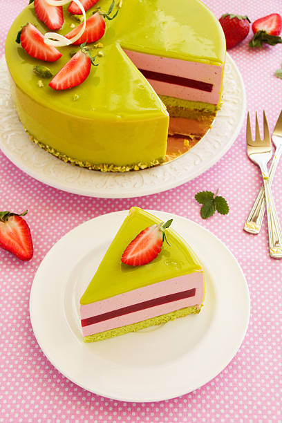 istock Delicious strawberry-pistachio mousse cake with a smooth glaze. 469983340