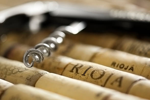 istock Bottle opening corkscrew lying on a pile of corks 469984483