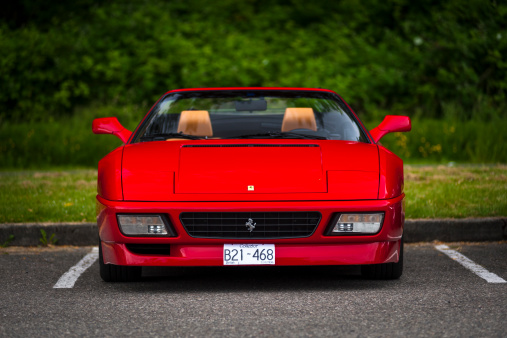 Vancouver, Canada - June 8, 2013: A classic Ferrari 348 Spider, convertible sports car is seen in a head-on view in an empty parking lot.
