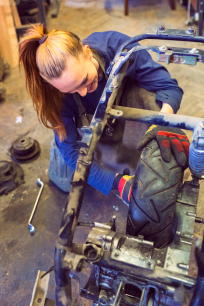 istock Female mechanic working on a custom motorbike 469986360