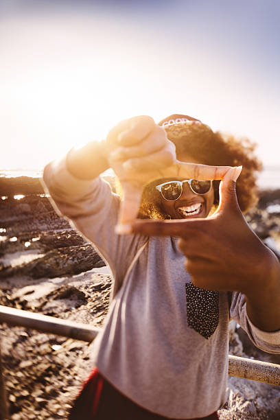 istock Afro hipster teen making a frame shape with her fingers 469986772