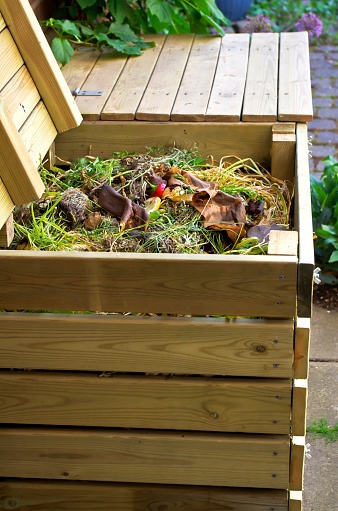 Compost bins made ​​of wood for vegetable kitchen and garden waste.