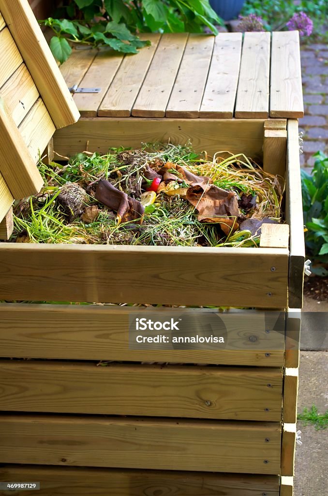 Compost in wooden box on sidewalk Compost bins made ​​of wood for vegetable kitchen and garden waste. Compost Bin Stock Photo