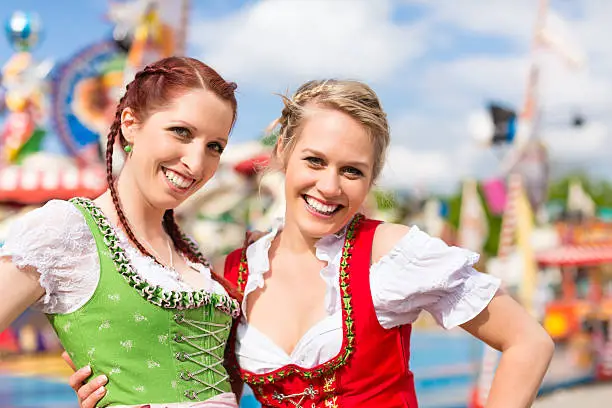 Young women in traditional Bavarian clothes - dirndl or tracht - on a festival or