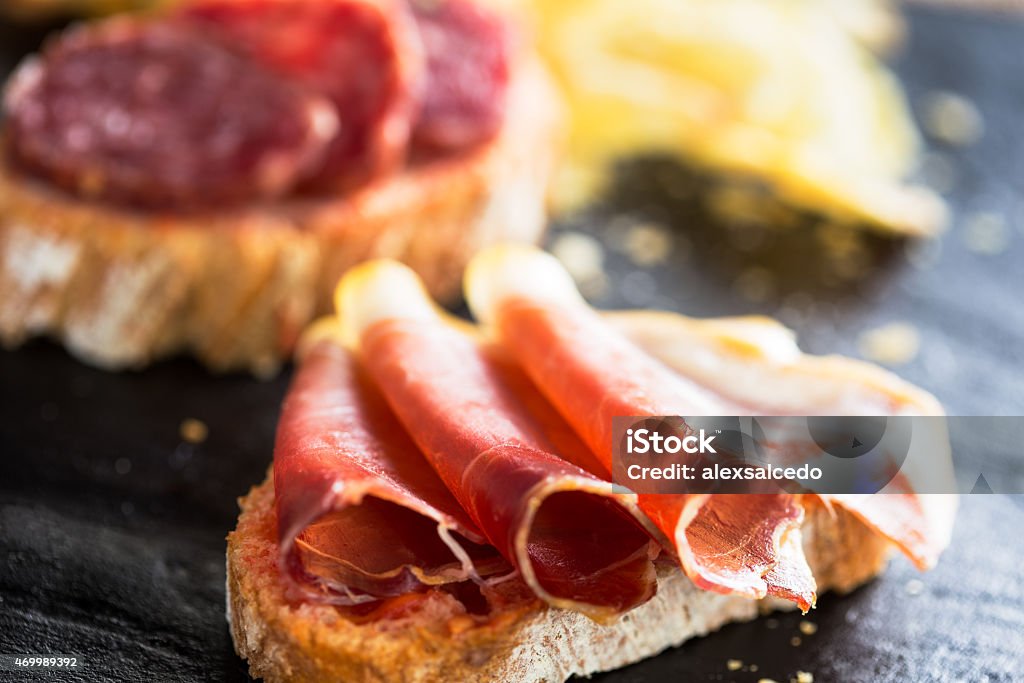 tapas Typical spanish appetizer called "pinchos" with spanish ham and slice of bread. 2015 Stock Photo