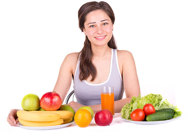 istock beautiful girl with fruit and vegetables on the table 469994042