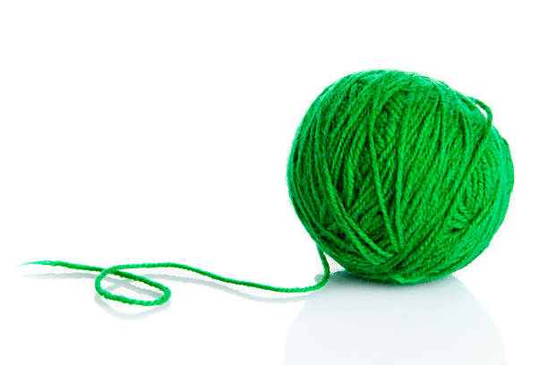 istock Green wool yarn ball isolated on white  background 469994381