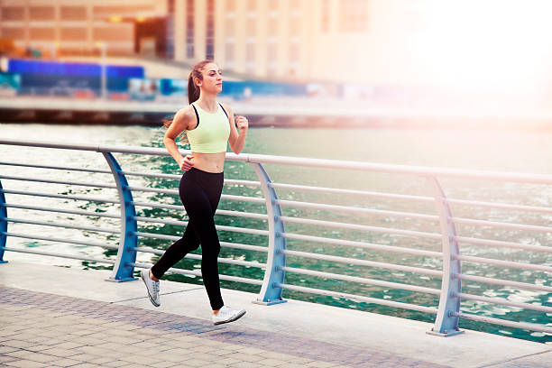istock Woman jogging in Dubai Marina. 469994502