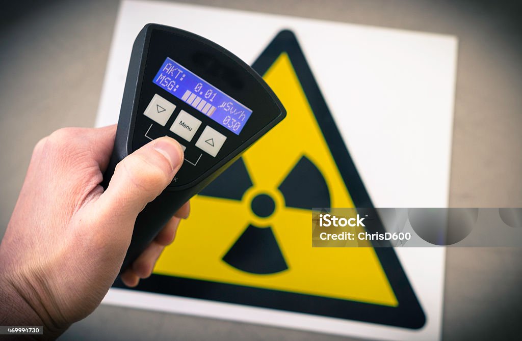 Measuring radiation levels Measuring radiation with a modern digital handheld device Radiation Stock Photo