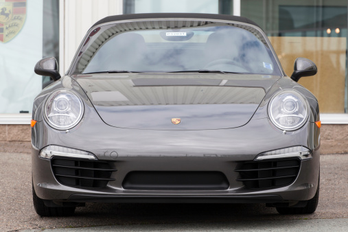 Halifax, Nova Scotia, Canada - June 3, 2012: A front view of a Porsche 911 Carrera S Cabriolet 991 Series on display at a Porsche dealership.  The 991 Carrera S Cabriolet features a 3.8-liter, 400 hp engine and is the first to use mostly aluminum construction.  It is only the third entirely new platform for the 911 since it's introduction in 1963.