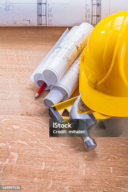 Blueprints Level Hammer Helmet On Wooden Boards Construction Con Stock Photo - Download Image Now