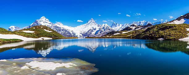 bachalpsee reflections - grindelwald european alps blue sky стоковые фото и изображения