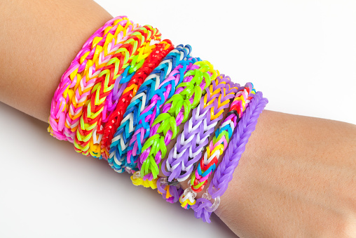 Colorful rubber rainbow loom band bracelets on hand, trendy kids fashion accessories