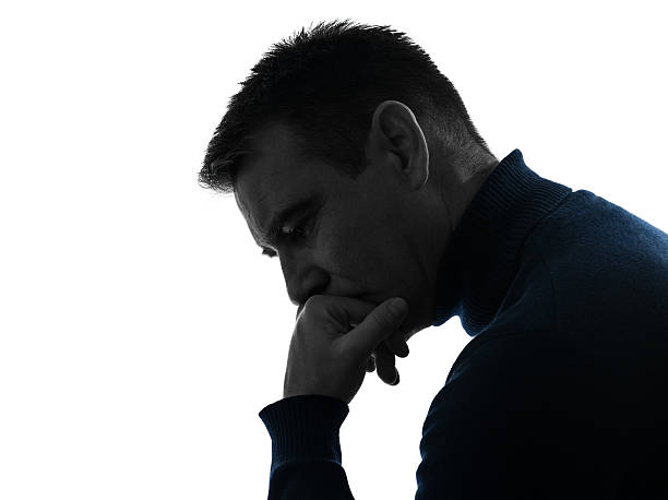 istock man serious thinking pensive silhouette portrait 469998839