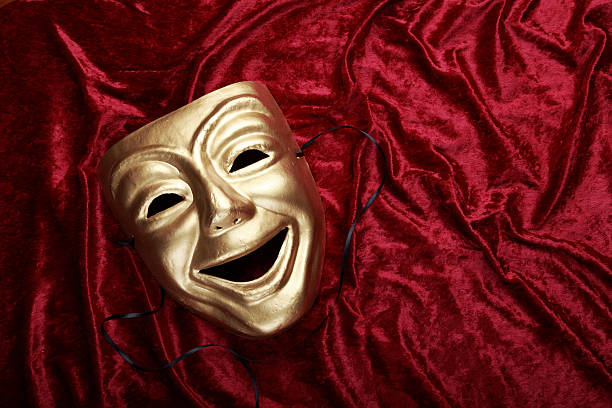 istock Classical theater comedy mask on a velvet curtain 469999123