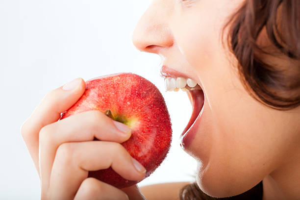 jovem mulher em um apple bites - chewing imagens e fotografias de stock