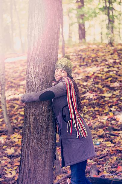 istock woman hugging a tree in autumn 470001283