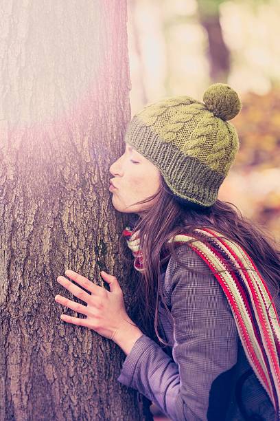 istock woman kissing a tree in autumn 470001285