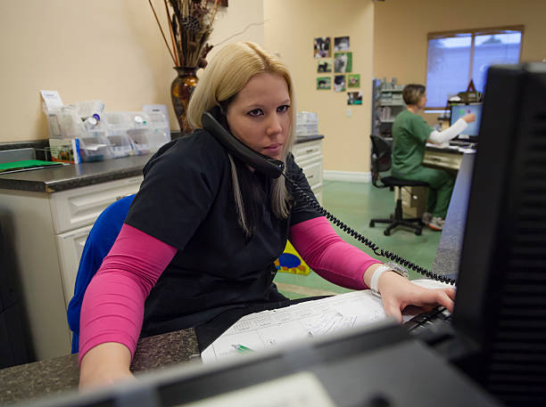 Receptionist On Phone In Animal Hospital Stock Photo - Download Image Now - Receptionist, Veterinarian, Hospital - iStock Receptionist On Phone In Animal Hospital Stock Photo - Download Image Now - Receptionist, Veterinarian, Hospital - iStock