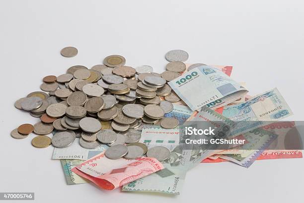 Stack Of Notes And Coins Stock Photo - Download Image Now - 2015, Abundance, Banking