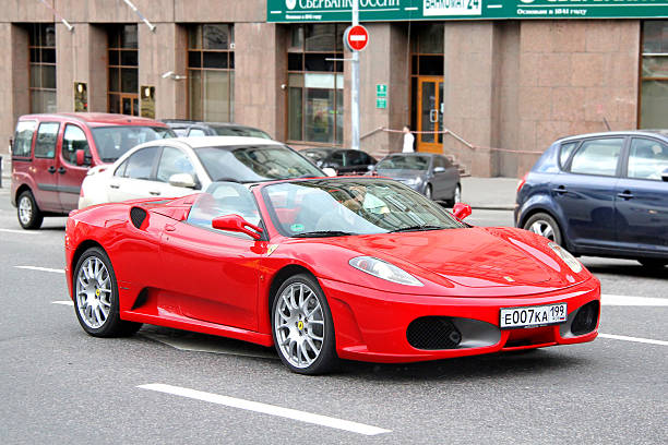 Moscow, Russia - June 2, 2013: Red Ferrari F430 Spider sportscar drives at the city street.