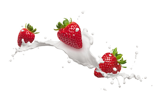 milk splash with strawberries isolated on white
