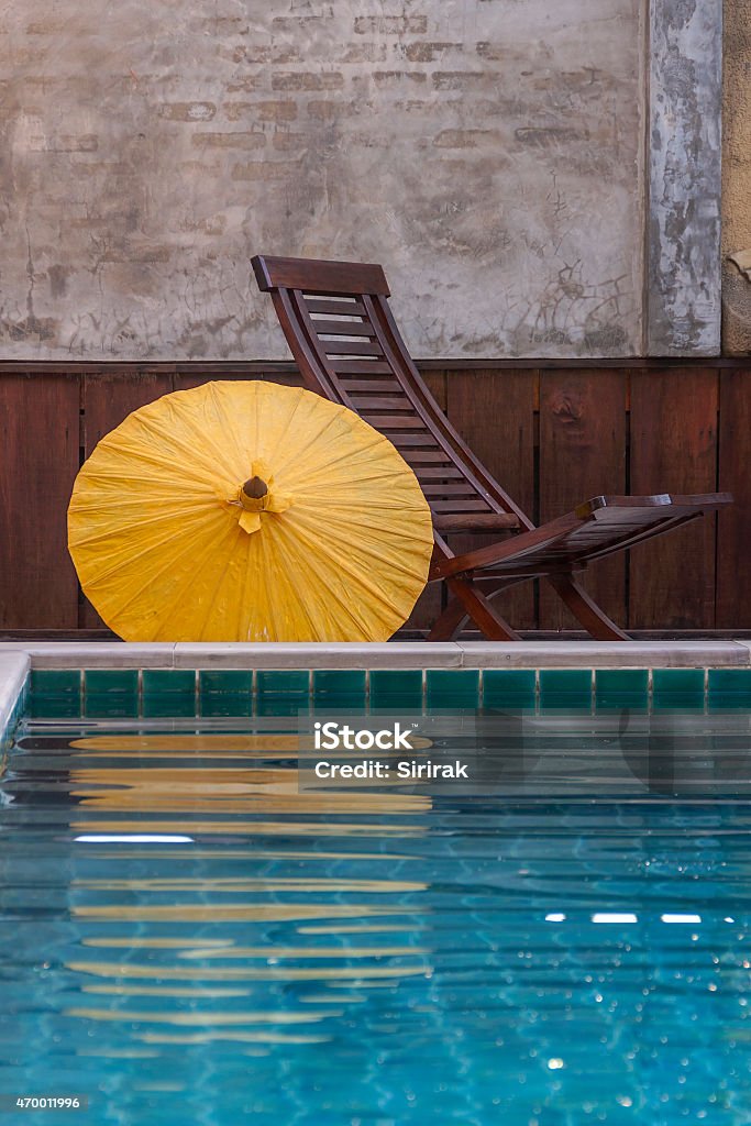 Design chair and umbrella at pool side Design chair and umbrella relax at pool side 2015 Stock Photo