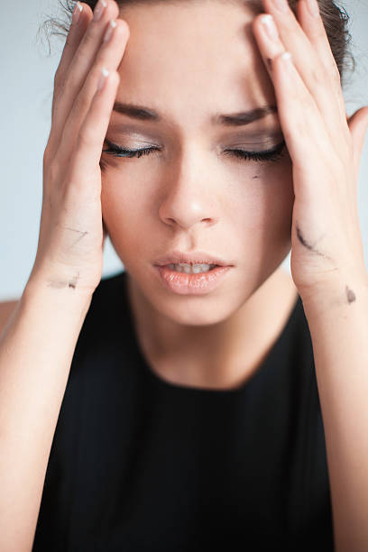 istock the upset woman touches with hands temples 470013670