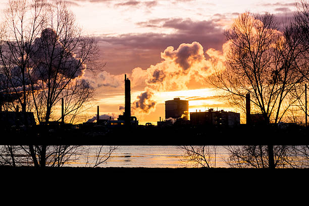 istock Factory with smokestacks at sunset 470016226