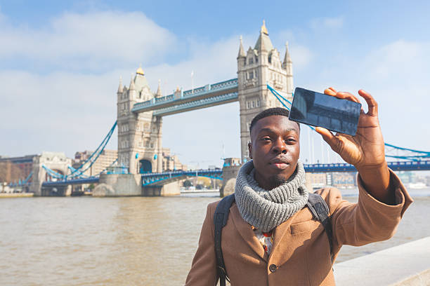 istock Man taking selfie in London with Tower Bridge on background 470016920