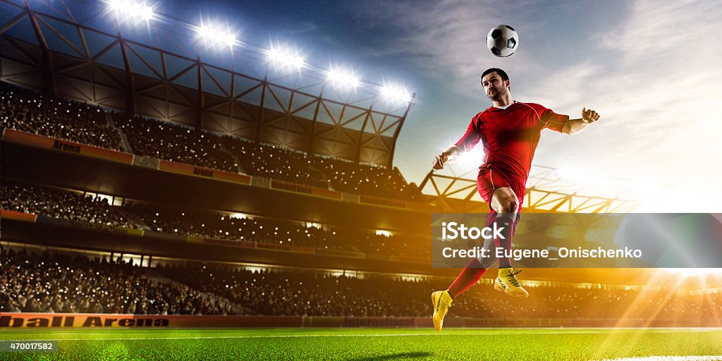 Soccer player in action panorama Soccer player in action on night stadium background panorama Soccer Stock Photo