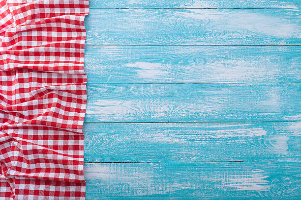 istock Wooden table covered with tablecloth cloth checkered red 470021338