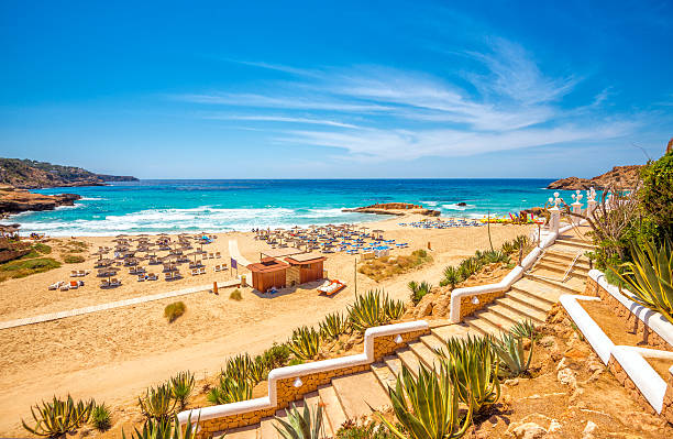 View on pre-seasonal Cala Tarida (Ibiza) View on the beautiful beach and bay of Cala Tarida, famous for its clear, sandy, shallow and turquoise waters. balearic islands stock pictures, royalty-free photos & images